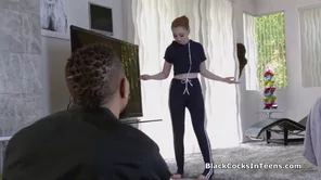 A red-haired teenage girl has rough anal sex with an African American man.